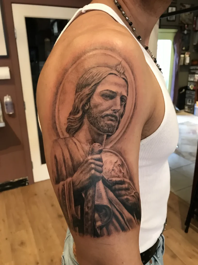 St. Jude with a halo and medallion, realistic black and grey on the shoulder